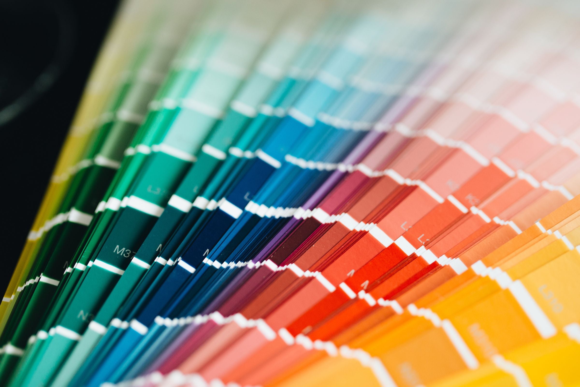 Fan of colour palette swatch cards spanning the full rainbow