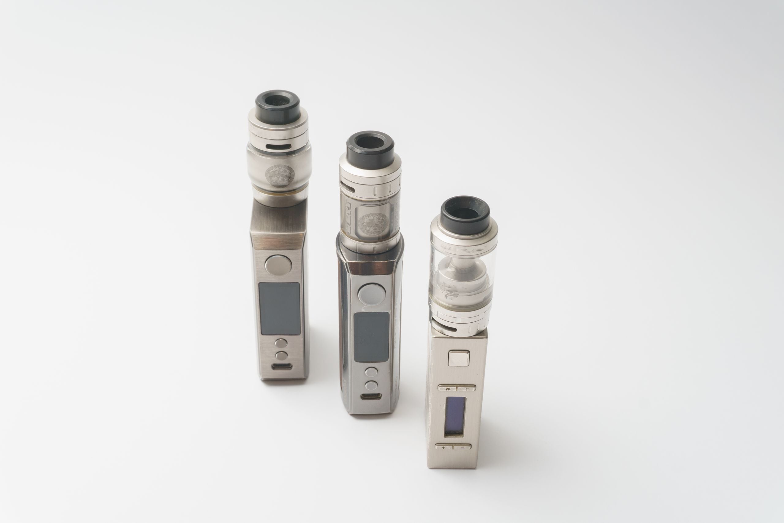 Three vape devices photographed as a product set