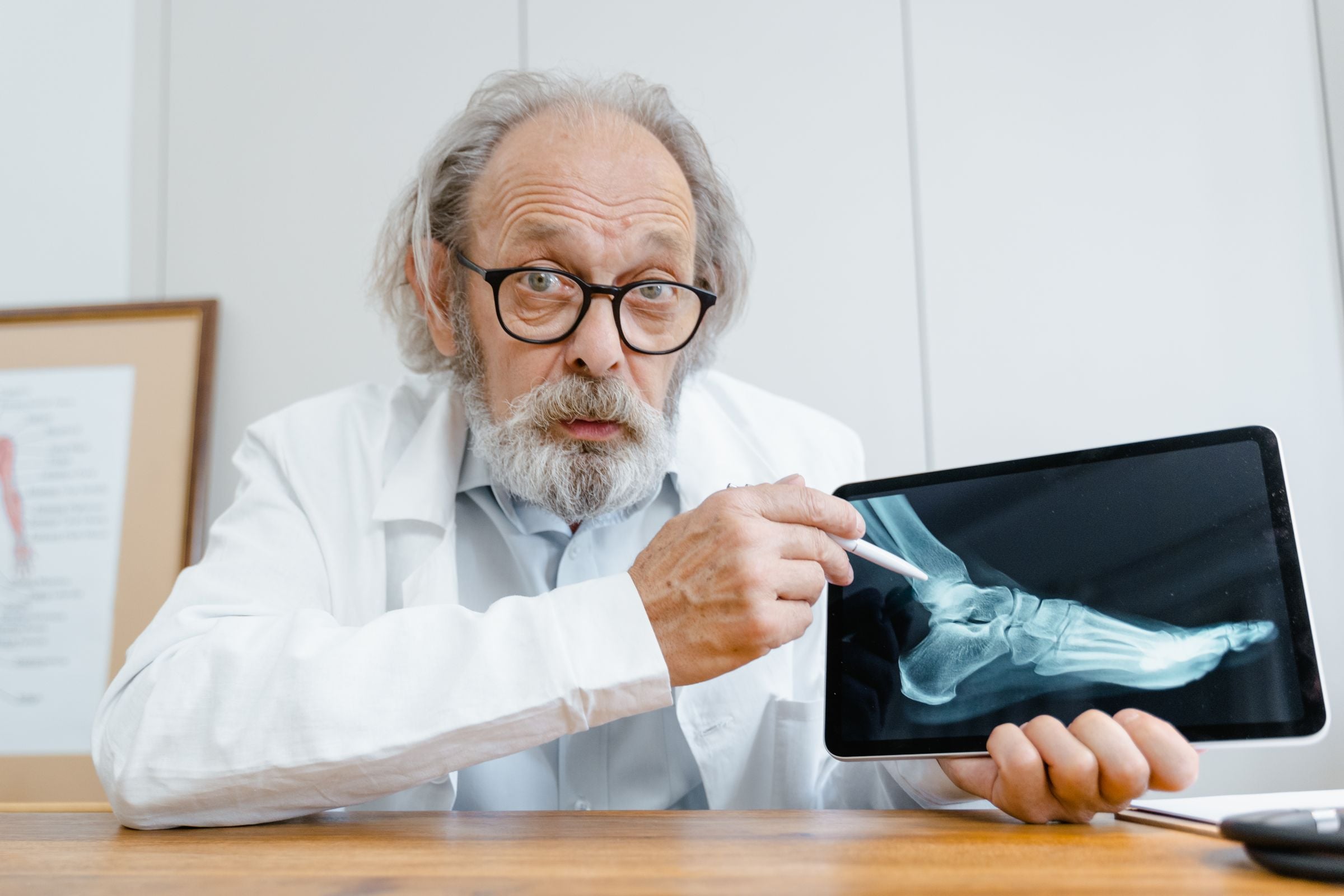 A doctor reviewing an X-ray on a tablet