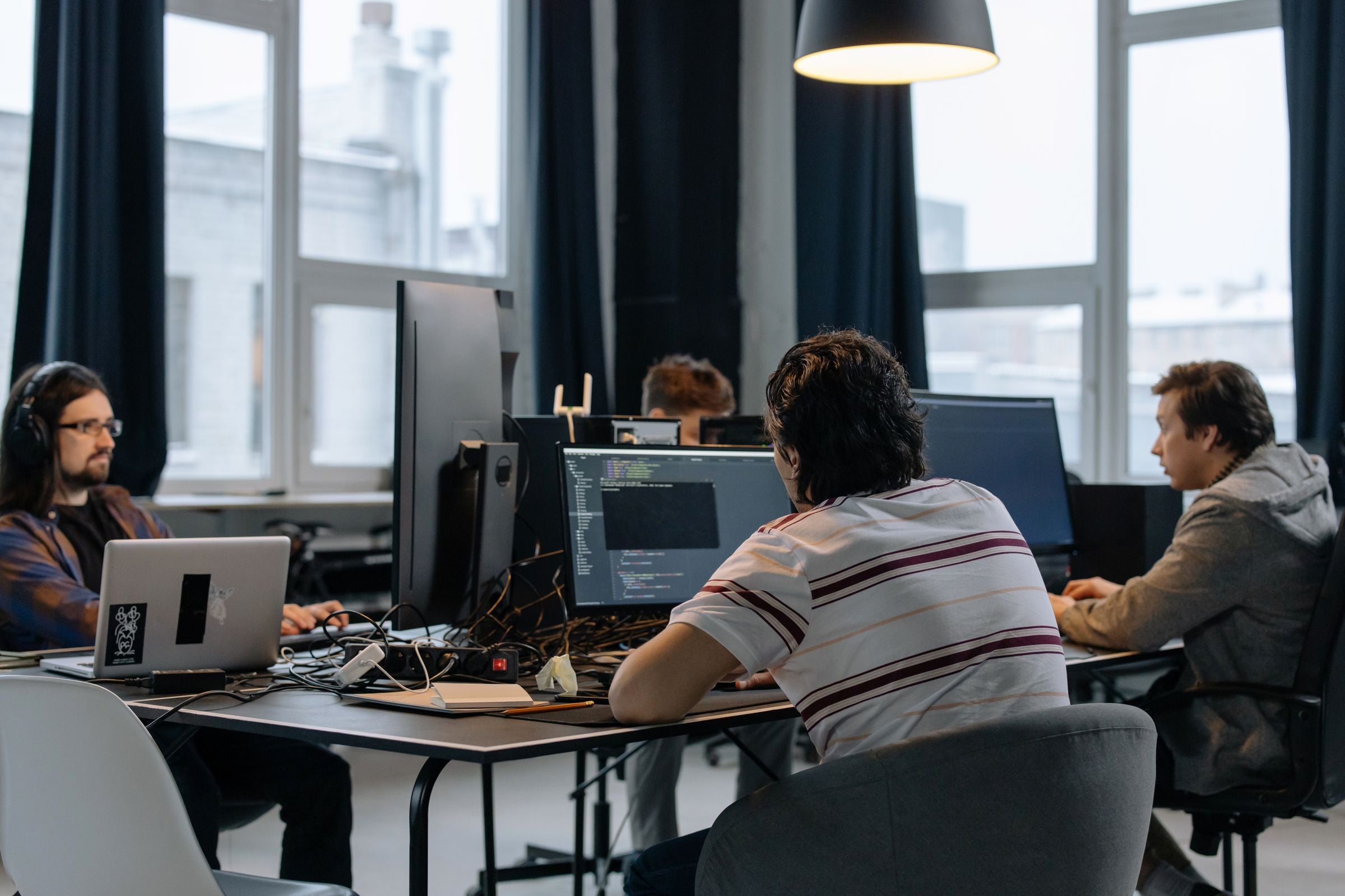 A team of developers working at monitors in a modern office