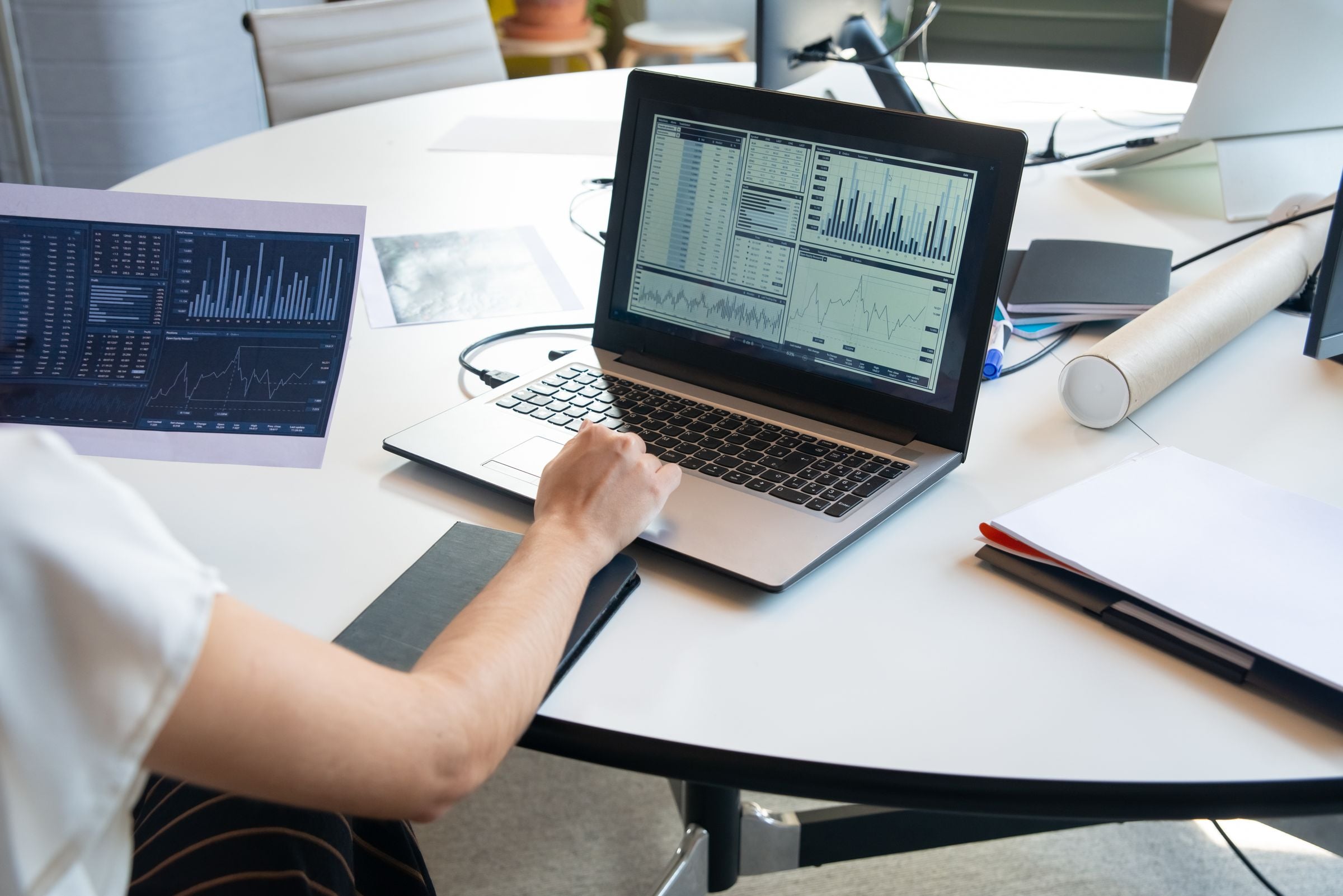 A business dashboard open on a laptop in a bright office